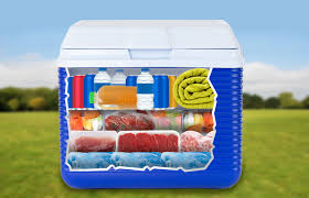 Packed camping cooler filled with organized food items, showing an efficient way to save space while keeping food cold
