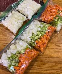 Pre-diced onions, celery, and carrots packed in ziplock bags for easy meal prep and space-saving cooler storage