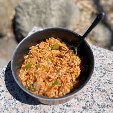 Zoomed in Jambalaya in a pan on a rock
